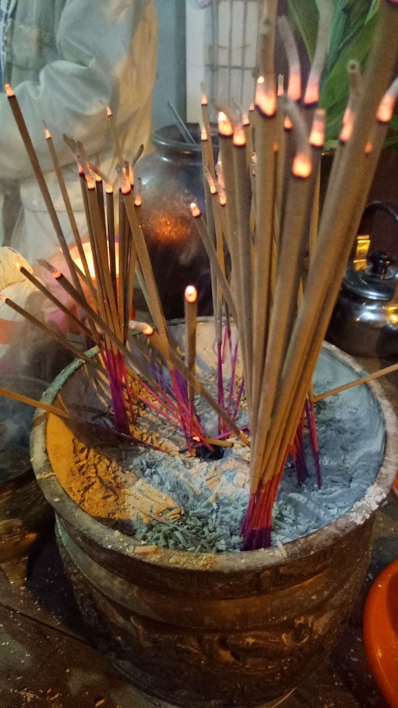 Lit incense sticks made from recycled temple waste